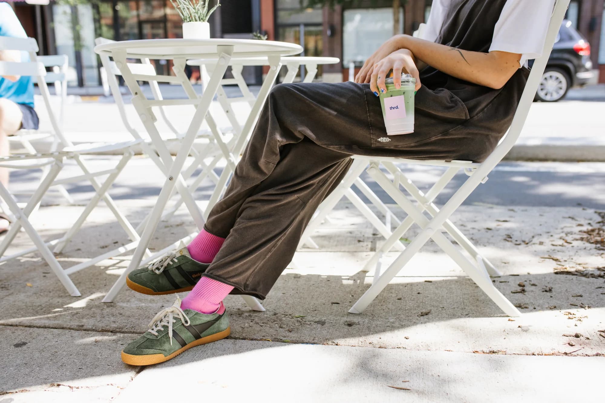 A thrd coffee iced matcha latte on the patio outside the Bucktown shop